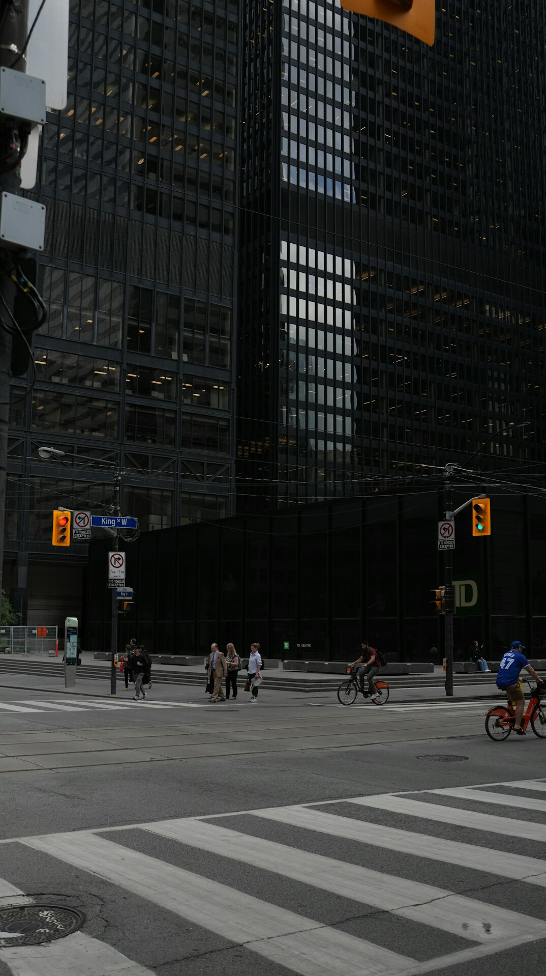 People crossing a busy downtown street in a Canadian city