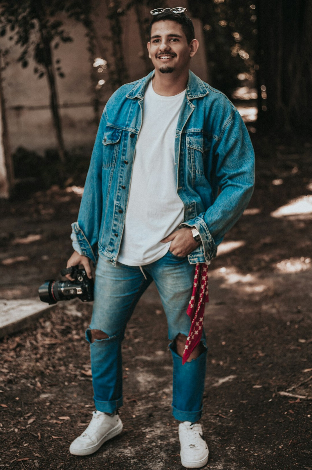 Portrait of a Latino man photographer wearing a denim jacket